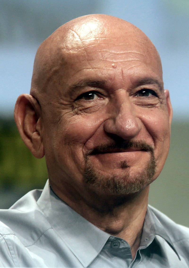 A headshot of Ben Kingsley smiling